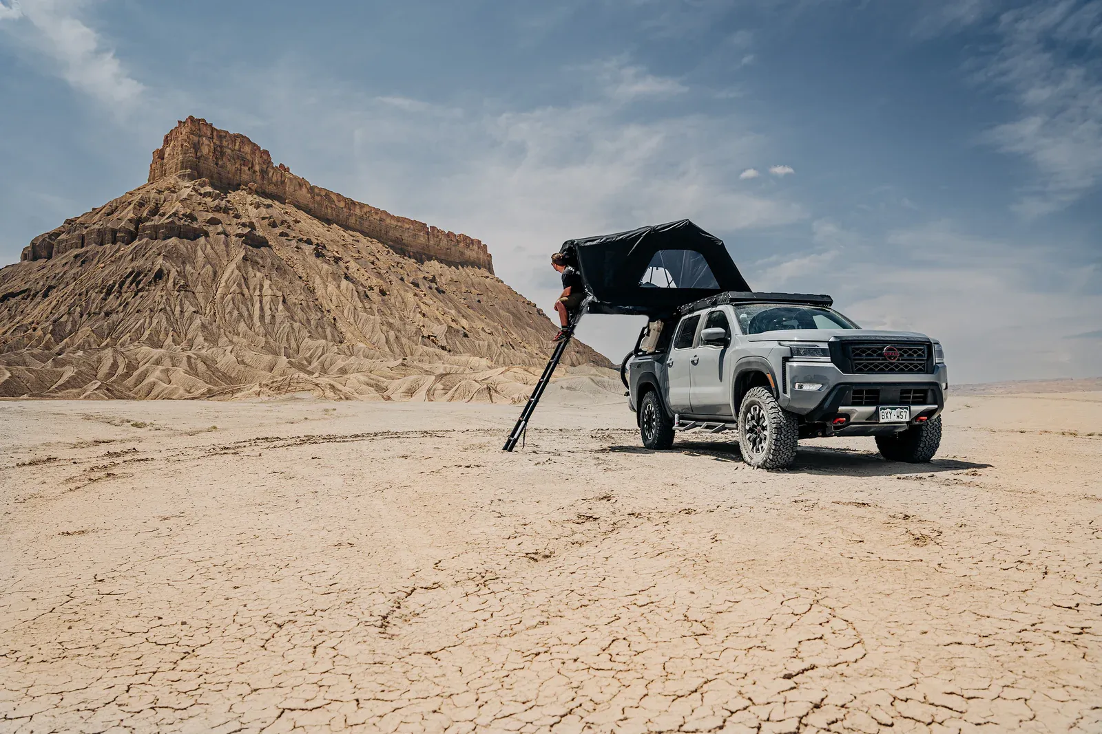 Truck in desert with roof top tent open